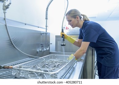 Worker Cleaning Surgical Instruments In Ultrasonic Bath In Surgical Instrument Factory