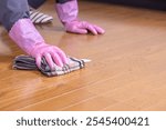 A worker cleaning and waxing a floor.