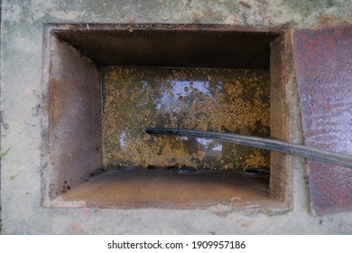 The Worker Clears The Clogged Sewer Drain Using Drain Clog Remover