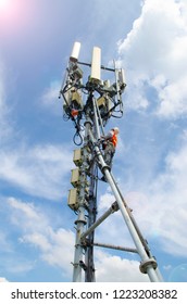 Worker Climbing To Maintenance The Telecommunication Tower ,climber Ascending The Tower,on Blue Sky Background.