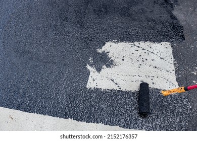 Worker Is Coating Tarmac Using A Brush Roller, Apply The First Basic Protective Layer Of Waterproofing.