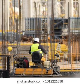 Worker with Concrete Pavements machine at the constructio site