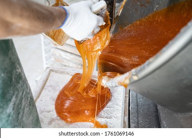 A Worker Confectionary Factory For A  Marmalade Or Caramel On The Scales For Rolling.