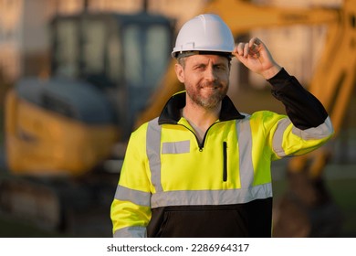 Worker at construction site. Builder constructor in hardhat. Construction man with helmet. Worker at construction with helmet. Industry worker at construction building. Builder at site building with