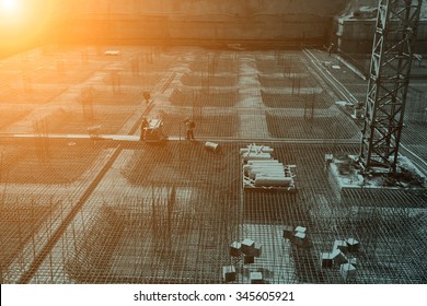 worker in the construction site making reinforcement metal framework for concrete pouring