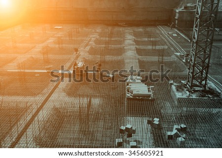 worker in the construction site making reinforcement metal framework for concrete pouring
