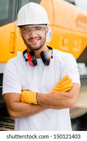 Worker At A Construction Site Working With Heavy Machines 