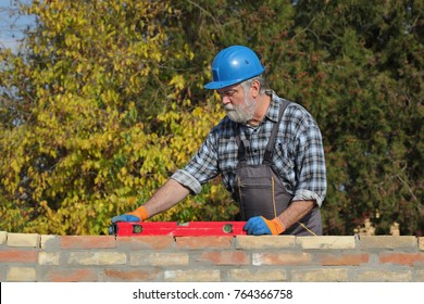 Worker Control Brick Wall Using Level Tool, Real People, No Retouch