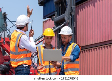 Worker control loading Container on delivery truck while caucasian man and woman working together with laptop in logistic, import export transportation business in containers distribution yard area.