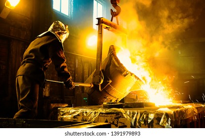 Worker controlling metal melting in furnaces. Workers operates at the metallurgical plant. The liquid metal is poured into molds. - Powered by Shutterstock