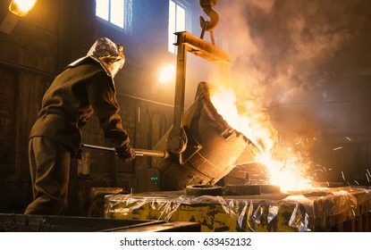 Worker controlling metal melting in furnaces. Workers operates at the metallurgical plant. The liquid metal is poured into molds. - Shutterstock ID 633452132