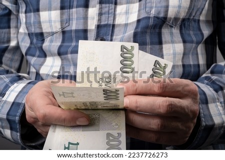 Worker Count Czech Money in cash, Finance in Czechia concept. Czech Koruna 2000 CZK banknotes.
