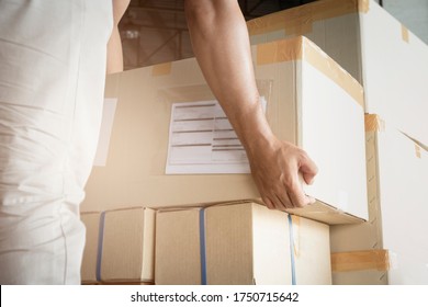 Worker Courier Lifting Shipments Boxes, Packaging, Cardboard Box, Warehouse Delivery Service Shipping Goods At Manufacturing Warehouse.
