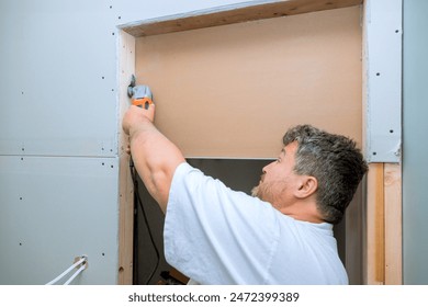 Worker cuts drywall with using multi tool