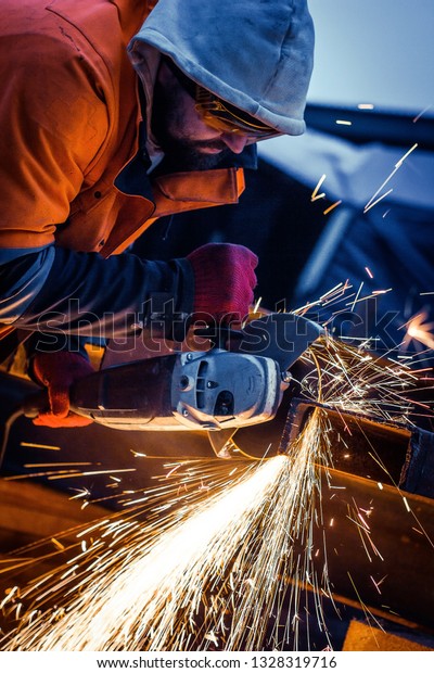 Worker cuts\
metal