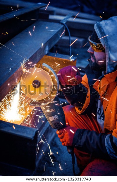 Worker cuts\
metal