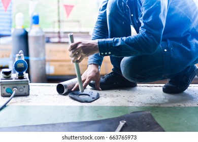 Worker Cutting Gasket On Site