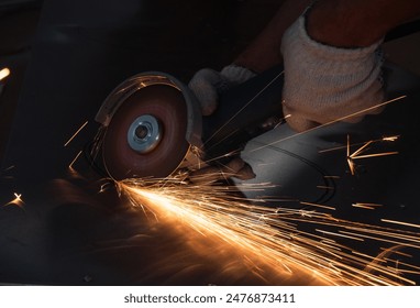 worker cutting a part with an angle grinder - Powered by Shutterstock