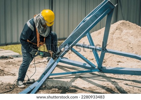 worker to cutting steel in construction site with Reciprocating saw or recip saw, saw used in construction and demolition work without creating any sparks.