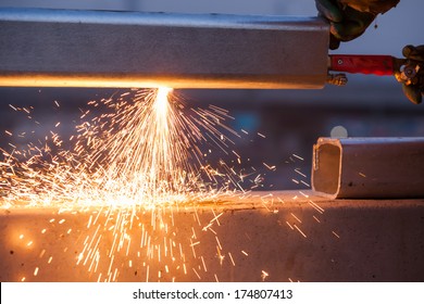 Worker Cutting Steel Pipe Using Metal Torch And Install Roadside Fence