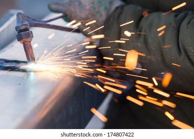 Worker Cutting Steel Pipe Using Metal Torch And Install Roadside Fence