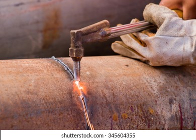 Worker Cutting Steel Pipe Using Metal Torch And Install Roadside Fence