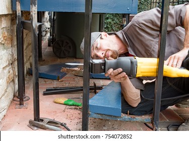 Worker Cutting Wrought Iron Post - Shutterstock ID 754072852