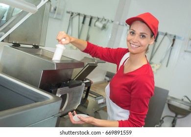 Worker Deep Frying In Industrial Kitchen