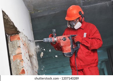 Worker With Demolition Hammer Breaking Interior Wall