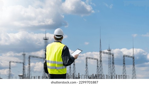 Worker with digital tablet on a background of power station

