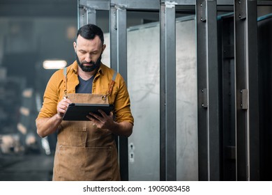 Worker with a digital tablet at the plant
