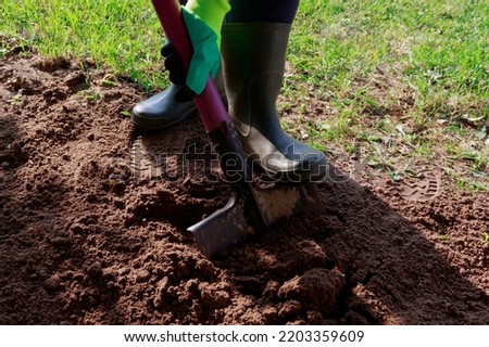Worker digs soil with shovel in garden, agriculture concept. boot on spade prepare for digging.
