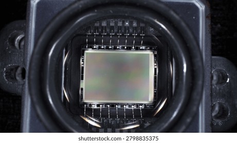 worker disassembled action camera to replace matrix on board microcircuit