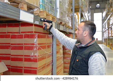 Worker in Distribution Warehouse With Handheld Barcode Scanner - Powered by Shutterstock