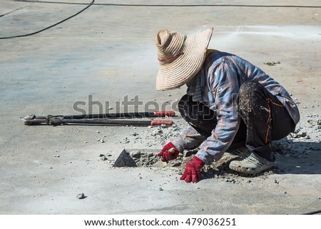 worker drilling cement.