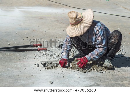 worker drilling cement.