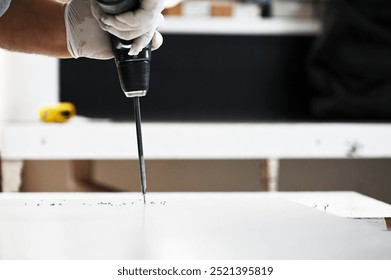 Worker drilling a hole with a drill
