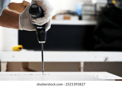 Worker drilling a hole with a drill