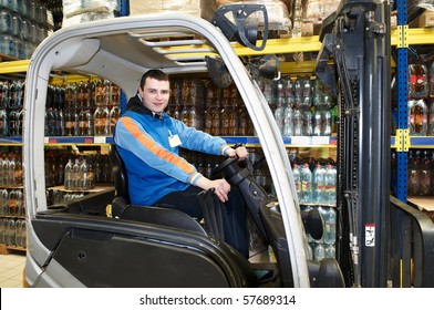 Worker Driver Of A Forklift Loader At Food Warehouse Distribution Works