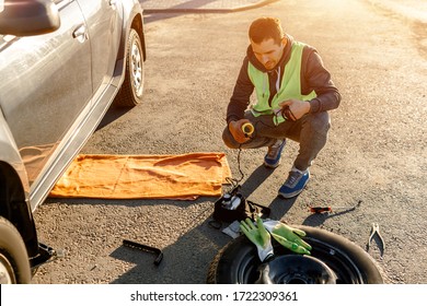 Worker Or Driver Tired Of Repairing A Car On The Side Of The Road