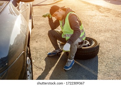 Worker Or Driver Tired Of Repairing A Car On The Side Of The Road