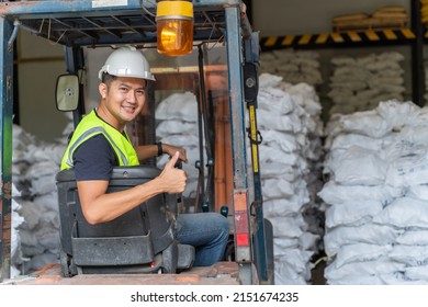 A Worker Driving A Forklift In Alum Or Chemical Warehouse.