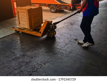 Worker driving forklift loading and unloading shipment carton boxes and goods on wooden pallet from container truck to warehouse cargo storage in logistics and transportation industrial 