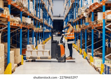 A worker is driving sustainable forklift and collecting goods for shipping in storage. - Powered by Shutterstock