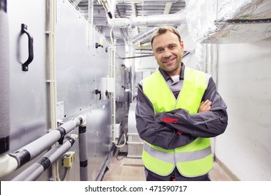 Worker In Electrical Switchgear Room Of CNC Plant