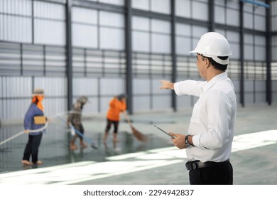Worker with empty warehouse or storehouse and preparing the area for placement.