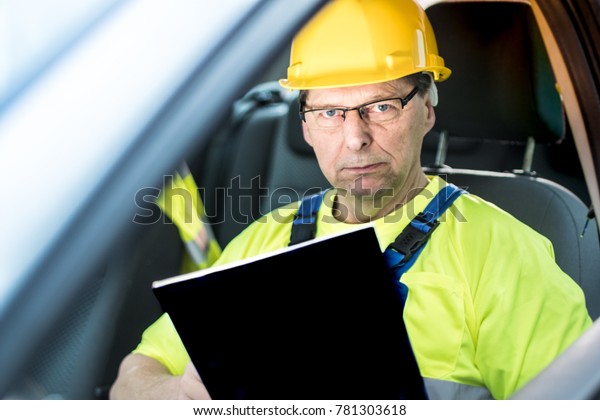 Worker / engineer in the car with a tablet in\
hand.\
Perfect for a building website, for tender documents, for\
the cover of a building application.\
for time management\
applications, to a construction\
w