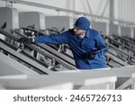 Worker engineer checks bearings on conveyor belt. Concept control quality product on modern food industry, factory production line