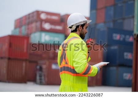 
worker or engineer export management team inspecting containers To manage the export of goods to foreign countries Large cargo shipping, container yard.