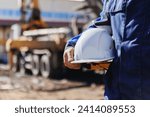 Worker engineer hold hard hat background of concrete mixer pouring foundation. Banner building Industry, construction site.